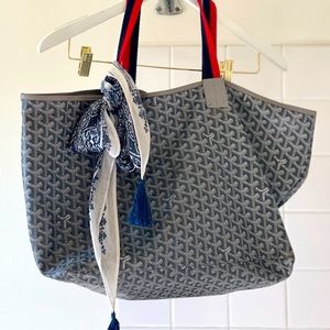Gray + white Goyard Anjou GM bag and wallet with Clare V. red + navy straps.